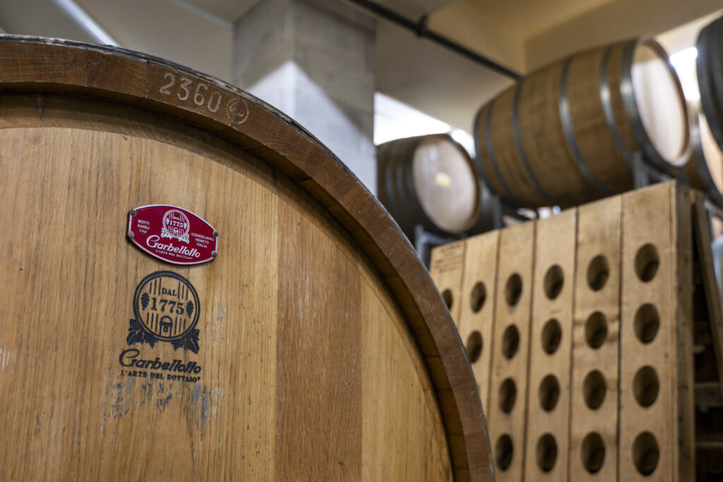 Barrels and a riddling rack in the wine cellar